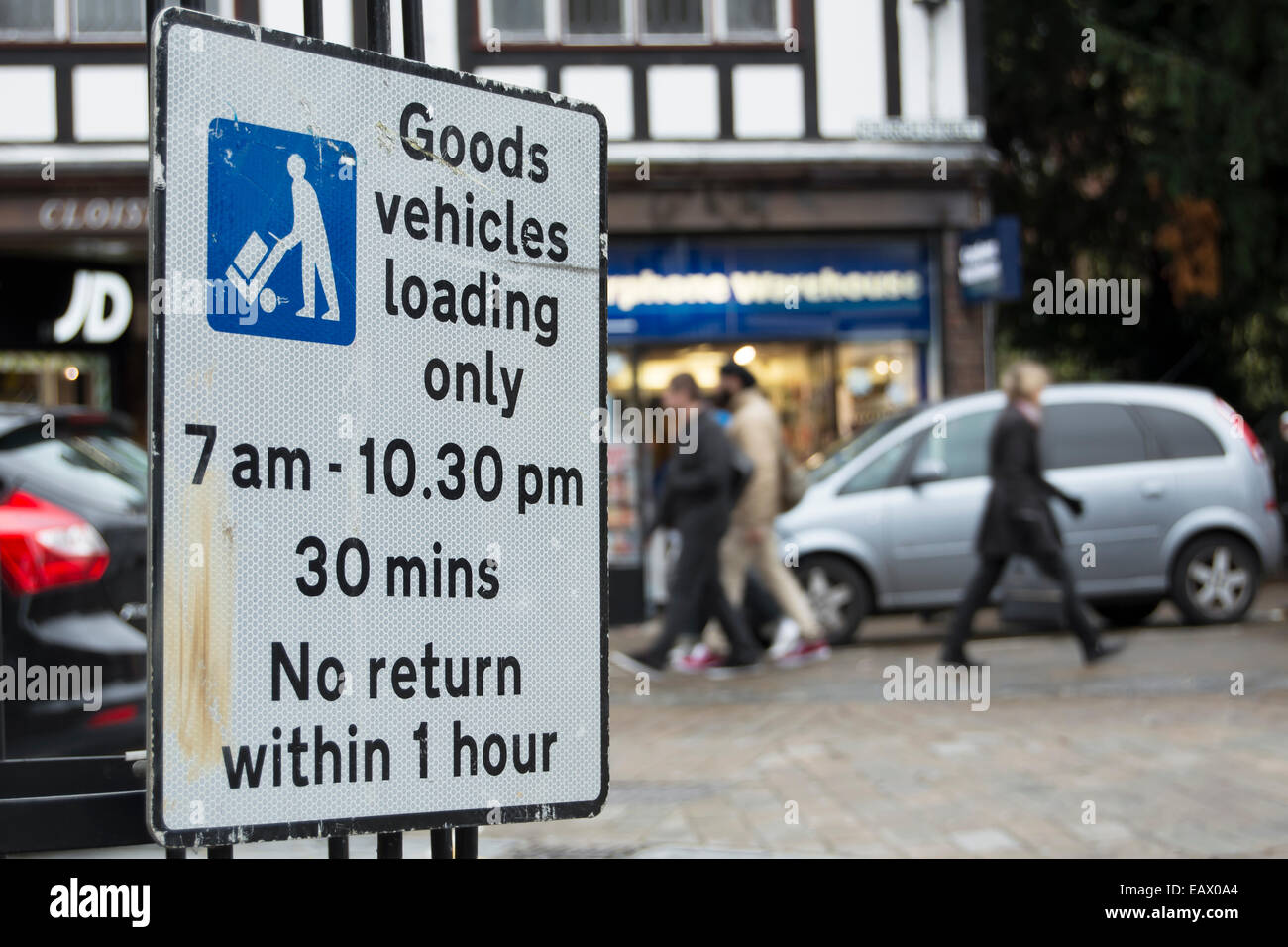 british road sign indicating parking only for goods vehicles unloading during times indicated Stock Photo