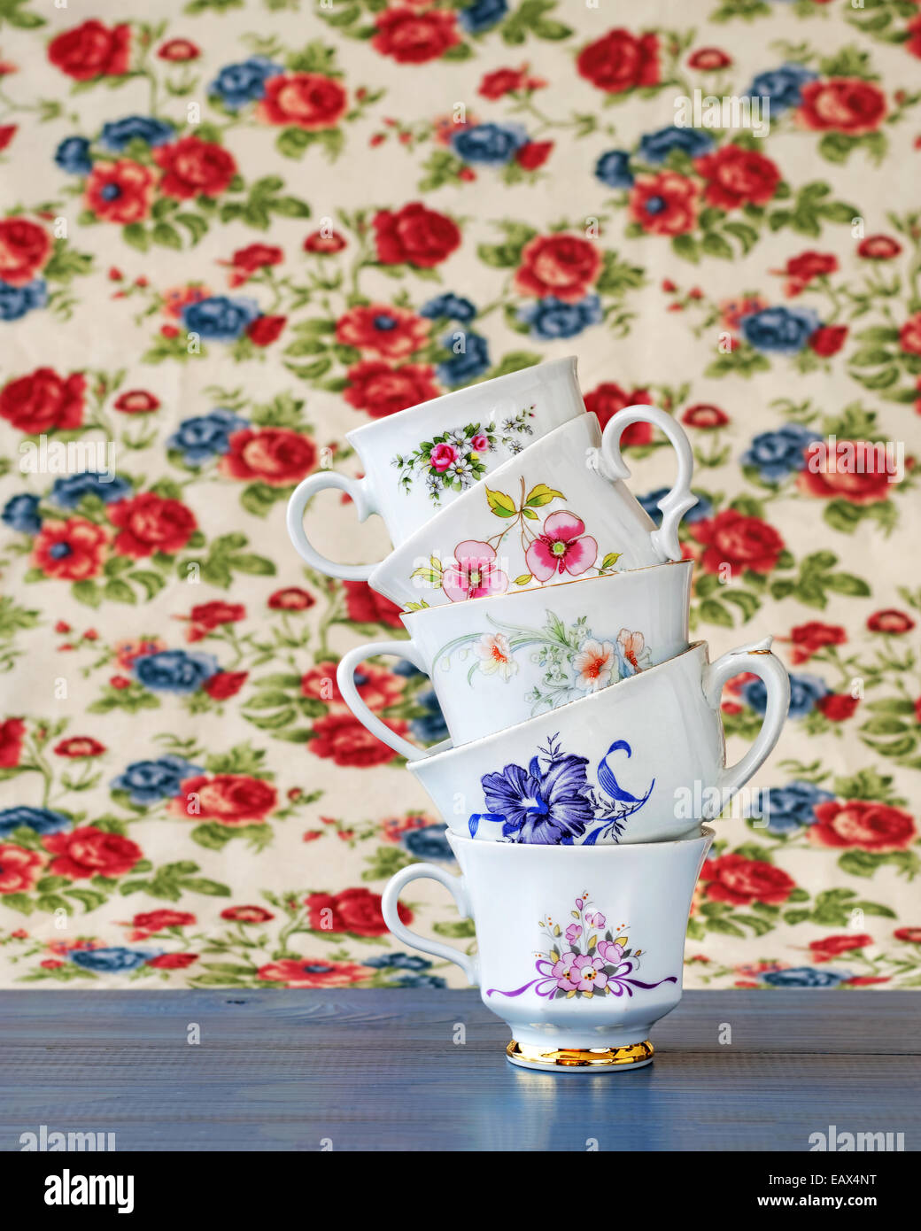 Stack of high tea cups with flower background Stock Photo