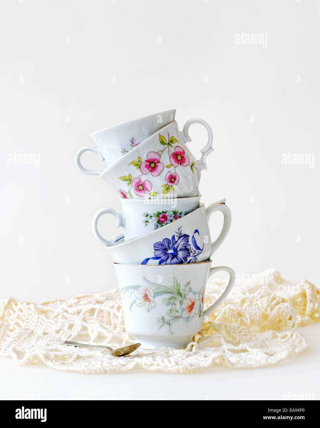 Stack of high tea cups on white Stock Photo