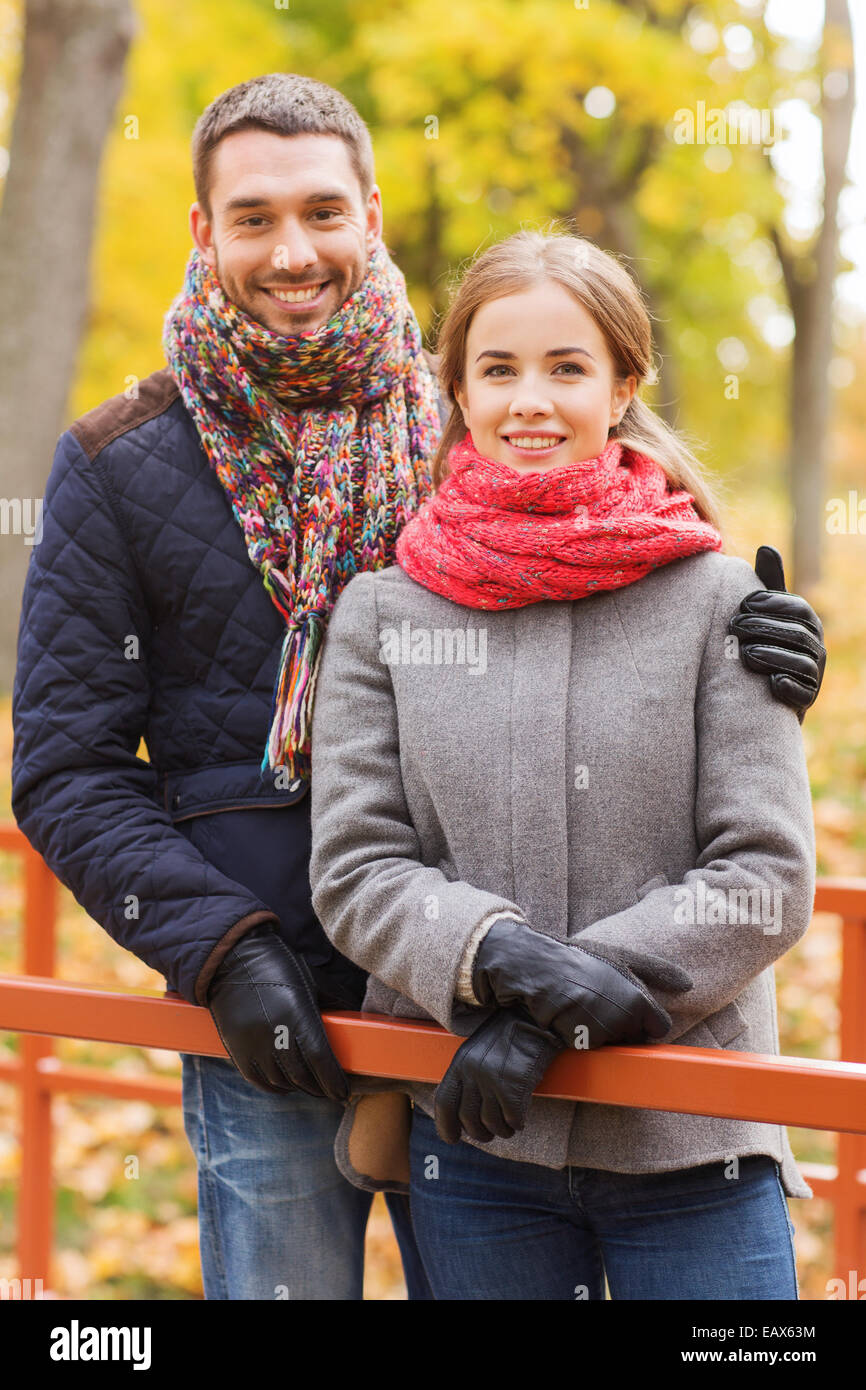 smiling couple hugging on bridge in autumn park Stock Photo - Alamy
