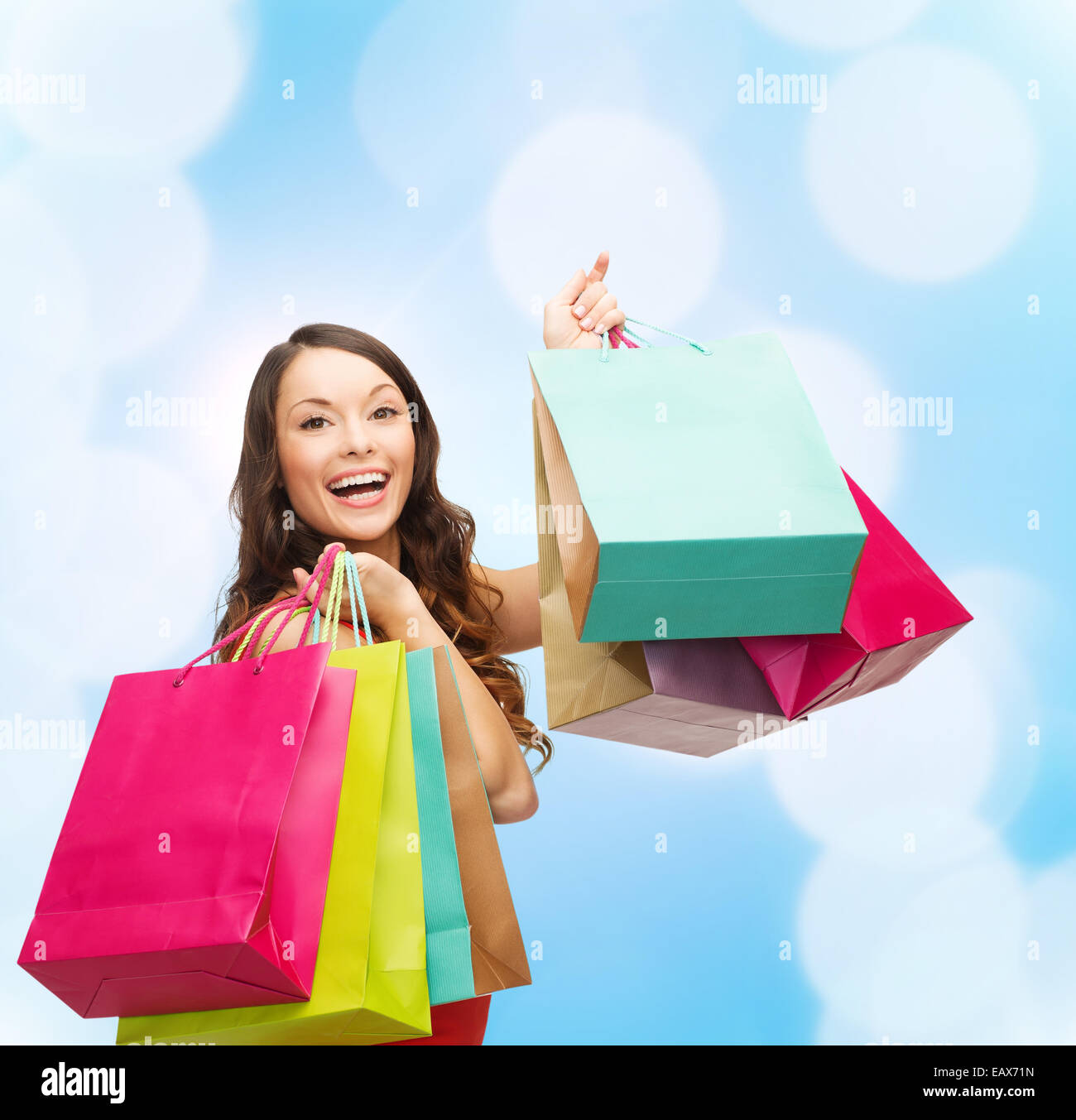smiling woman with colorful shopping bags Stock Photo