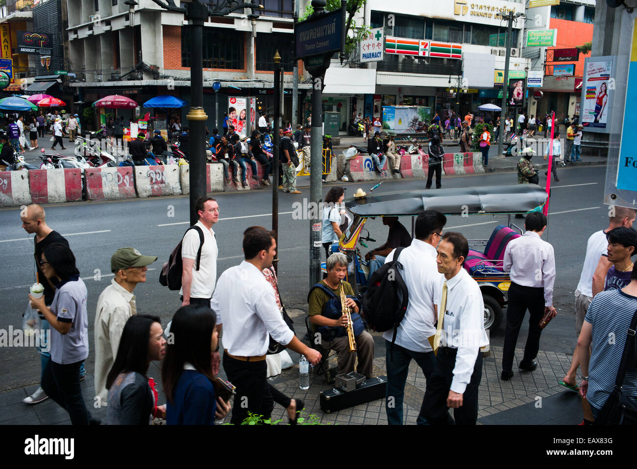 Blind old man playing saxophone on Silom road, Bangkok, Thailand Stock