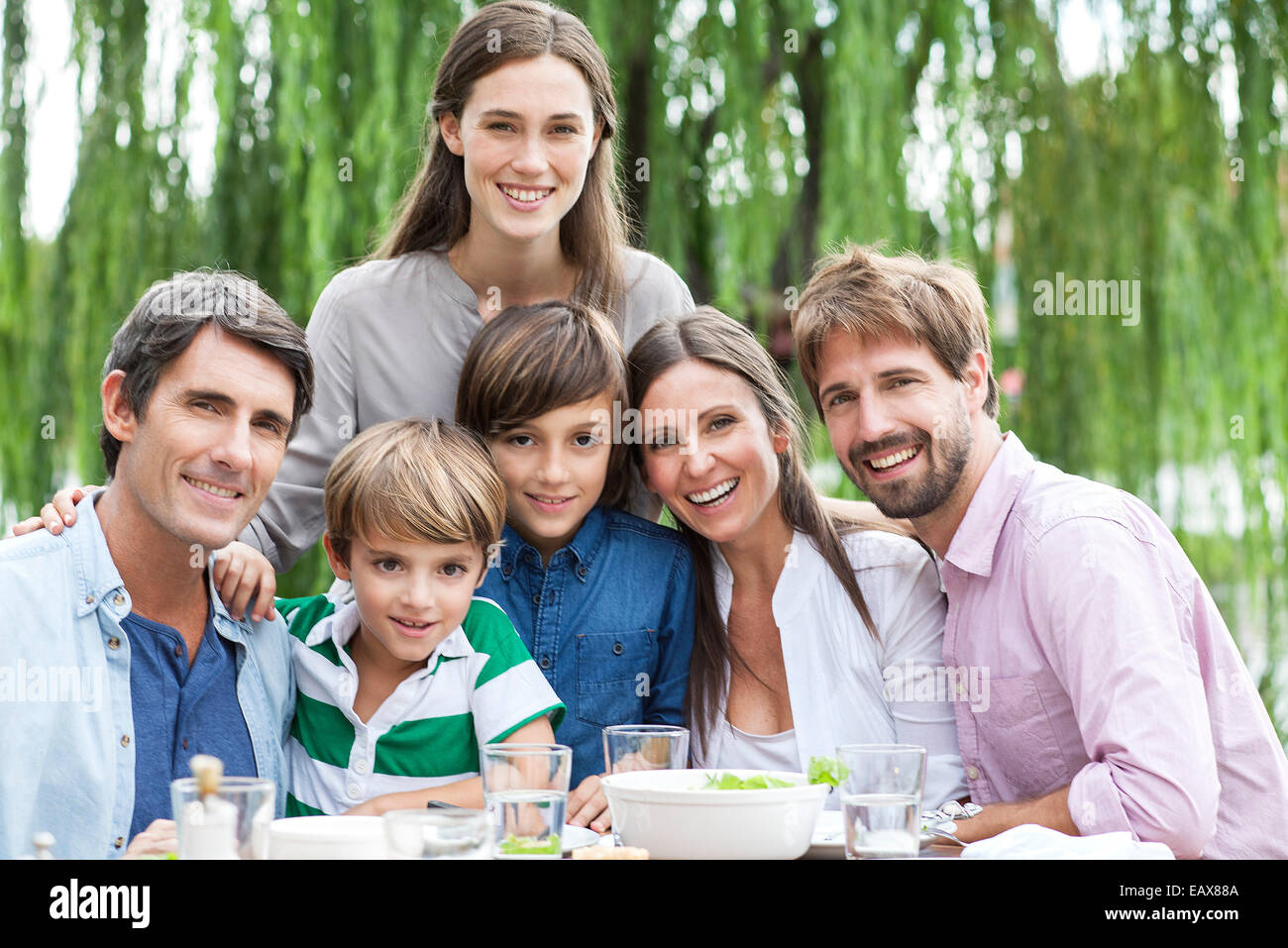 Family posing for portrait at outdoor gathering Stock Photo