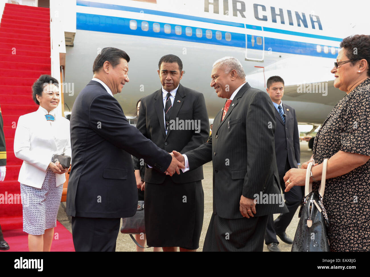 Nadi, Fiji. 21st Nov, 2014. Chinese President Xi Jinping (2nd L) and his wife Peng Liyuan (1st L) are greeted by Fijian Prime Minister Josaia Voreqe Bainimarama (2nd R) and his wife at the airport in Nadi, Fiji, Nov. 21, 2014. Xi is paying a state visit to Fiji, the first in history by a Chinese president. © Li Xueren/Xinhua/Alamy Live News Stock Photo