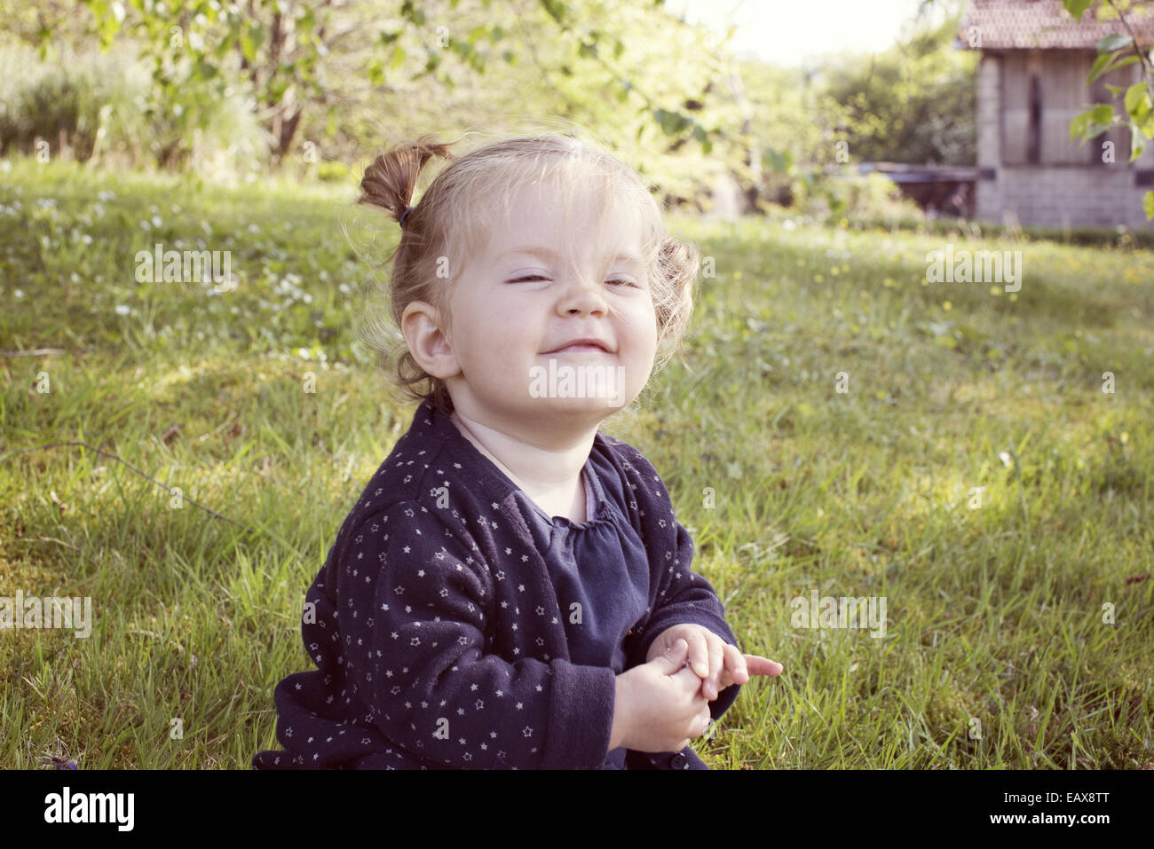 Baby girl smiling outdoors Stock Photo