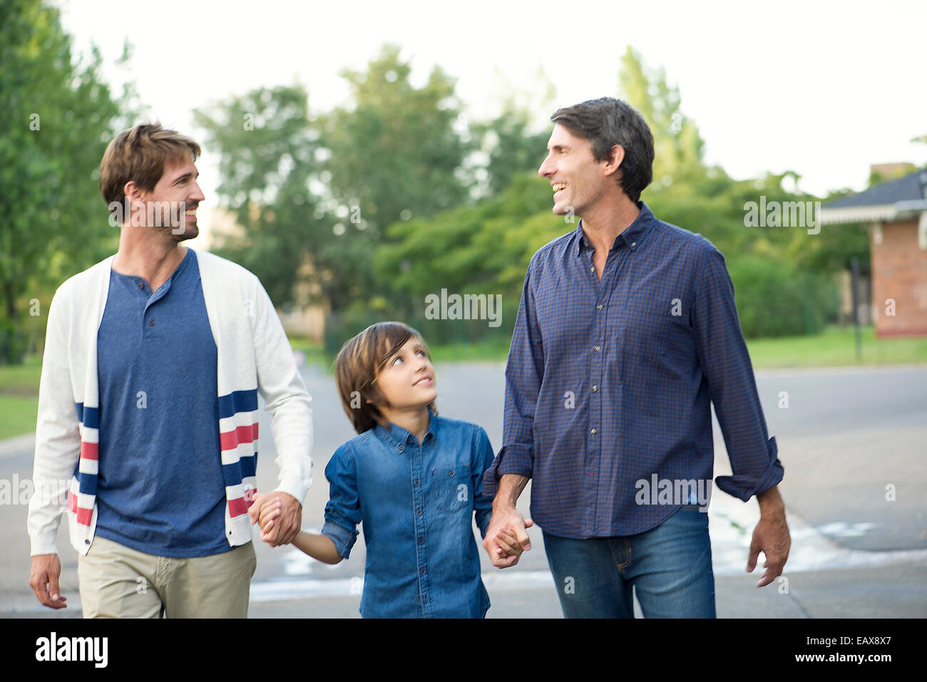 Fathers holding hands with son outdoors Stock Photo