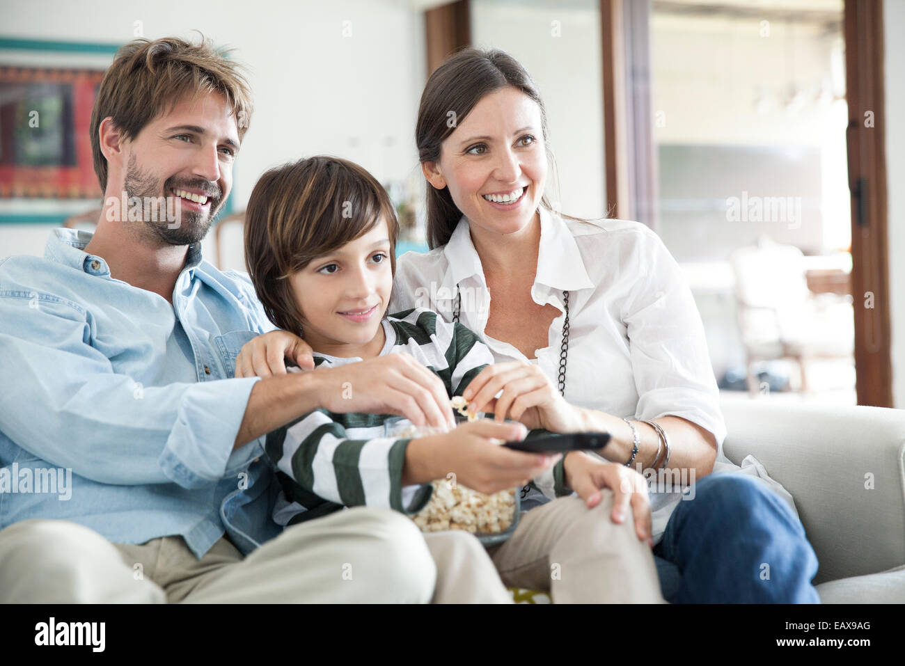 Family watching TV together Stock Photo
