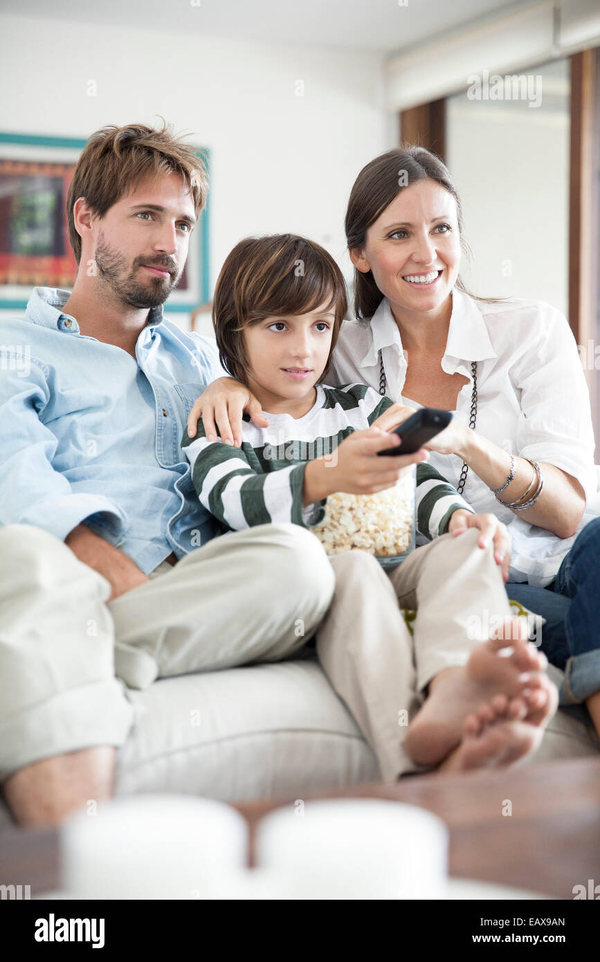 Family watching TV together Stock Photo