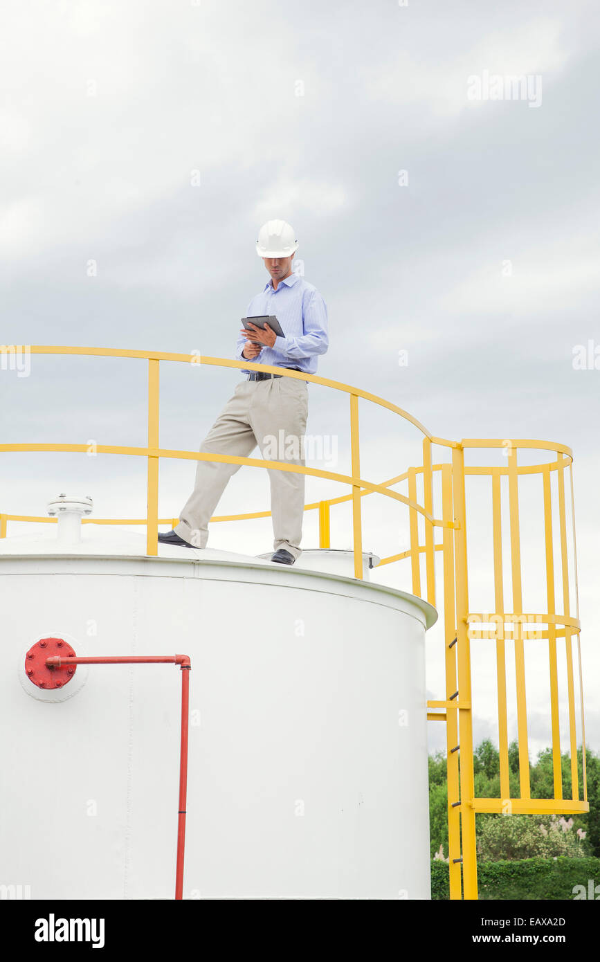 Engineer inspecting chemical storage tank Stock Photo Alamy