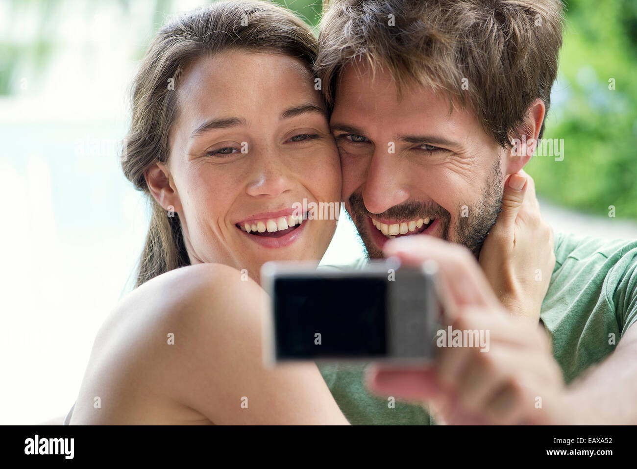 Young couple taking selfie with digital camera Stock Photo