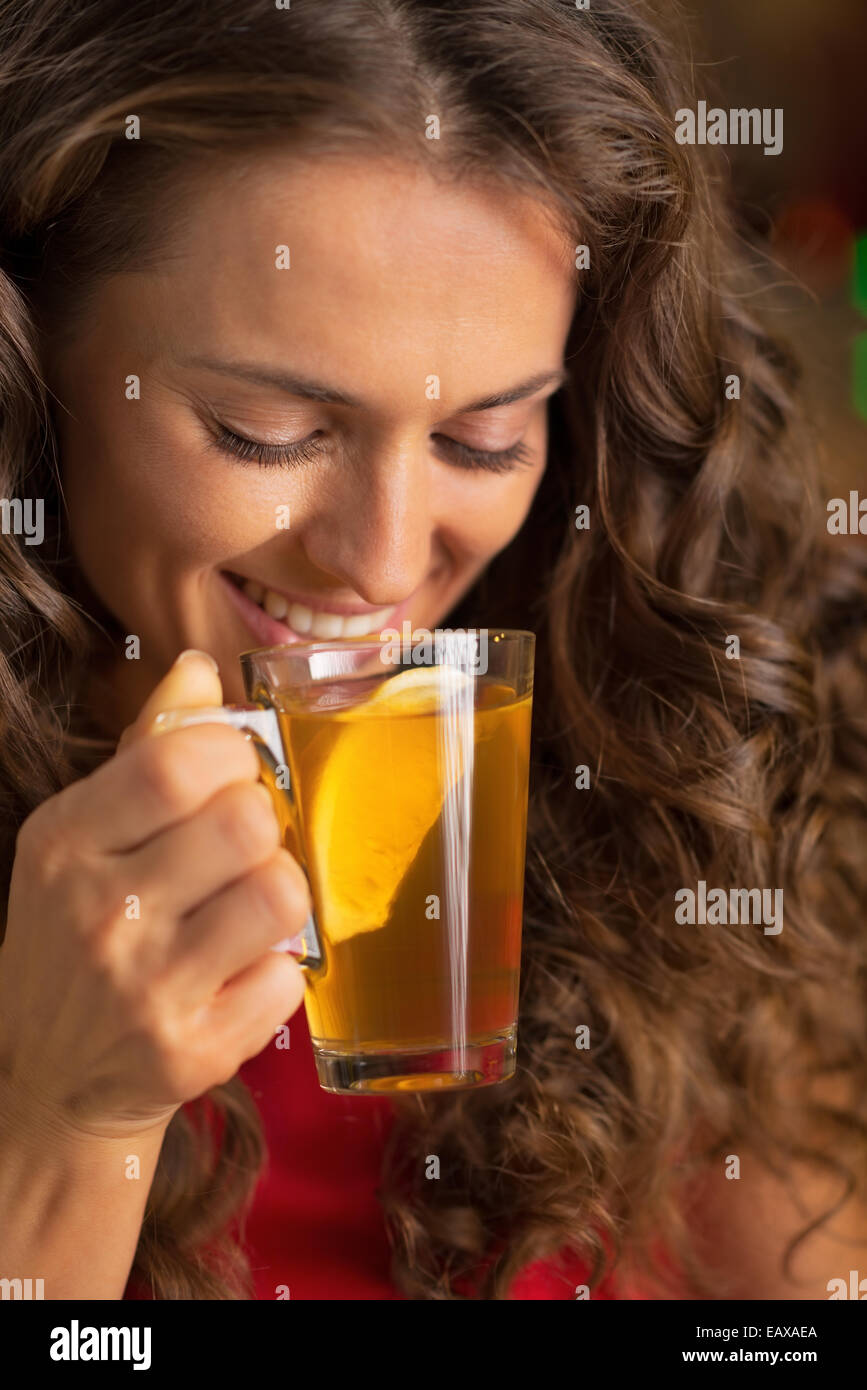 Portrait of happy young woman drinking tea Stock Photo