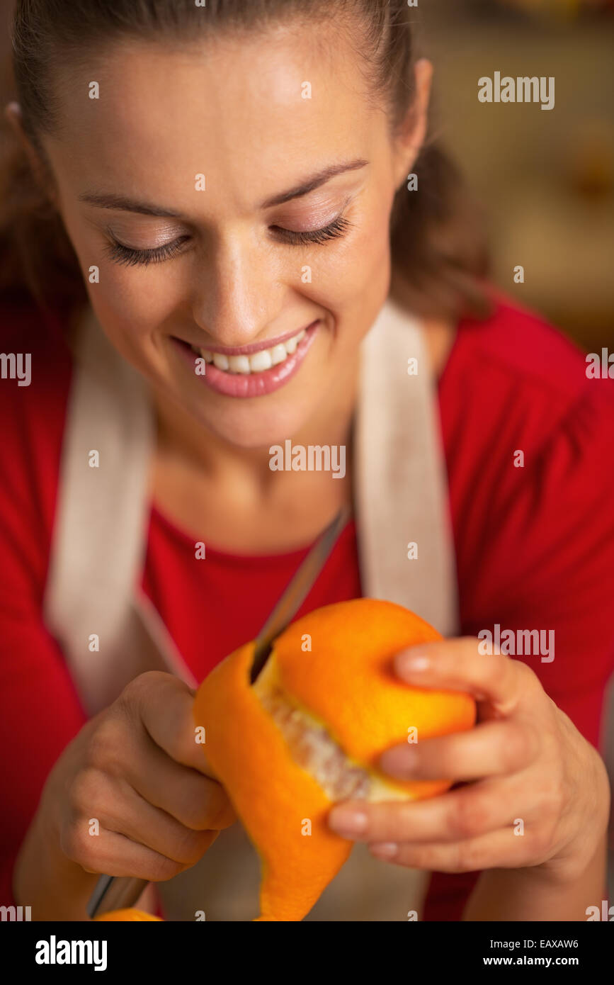Portrait of young housewife removing orange peel Stock Photo Alamy