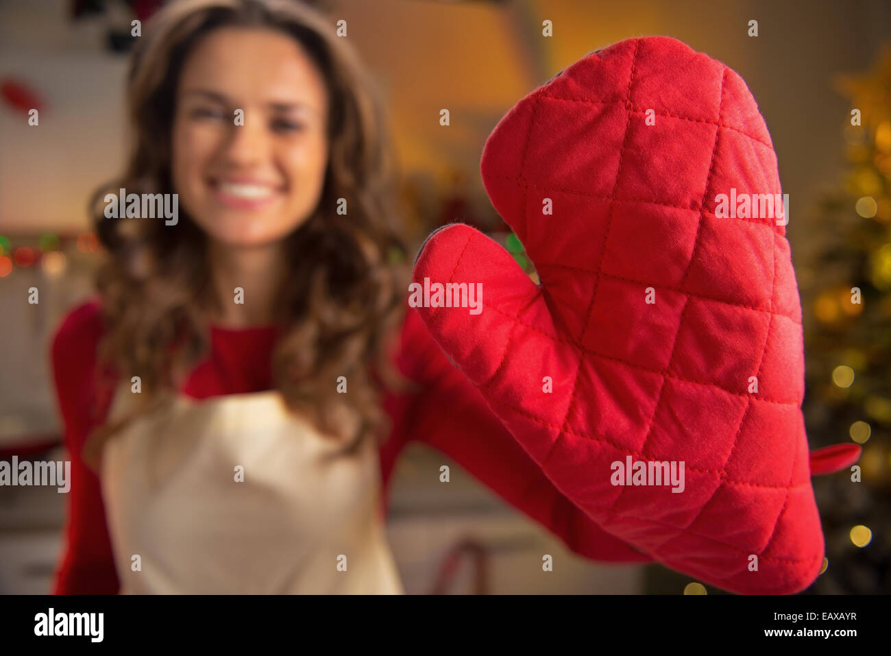 Closeup on young housewife showing red kitchen gloves Stock Photo - Alamy