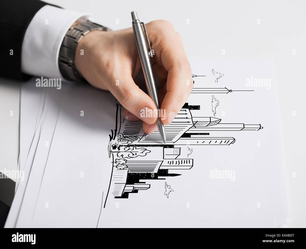close up of male hand with pen drawing graph Stock Photo