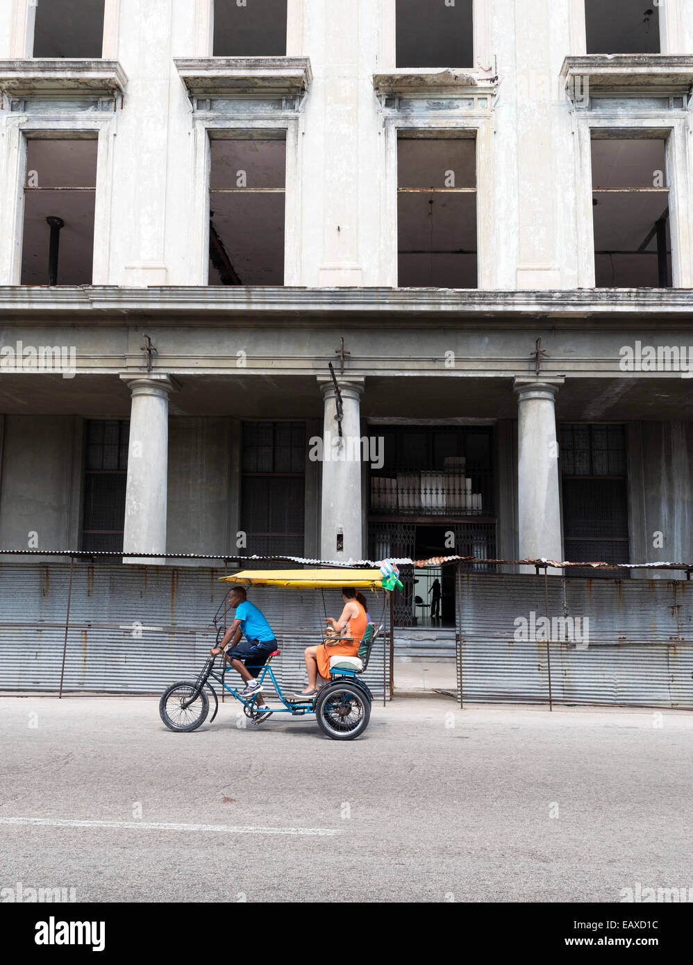 HAVANA - MAY 5, 2014: The urban cityscape, pedicab on the road on May 5, 2014 in Havana, Cuba Stock Photo