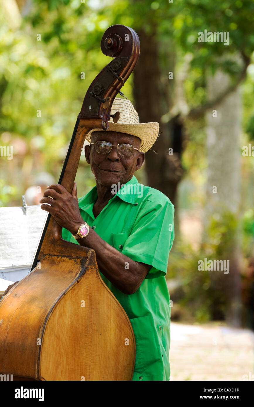 PINAR DEL RIO, CUBA - MAY 7, 2014: Old man plays the contrabass. Cuban music is an attraction for the over 2 million tourists wh Stock Photo