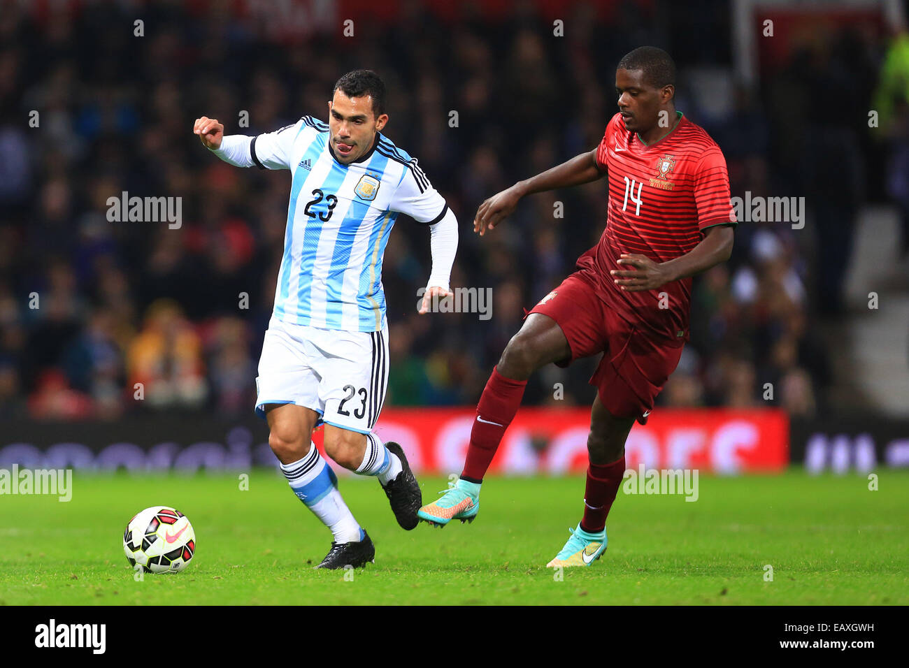 Nov. 18, 2014 - Manchester, United Kingdom - Carlos Tevez of Argentina and William Carvalho of Portugal - Argentina vs. Portugal - International Friendly - Old Trafford - Manchester - 18/11/2014 Pic Philip Oldham/Sportimage. Stock Photo