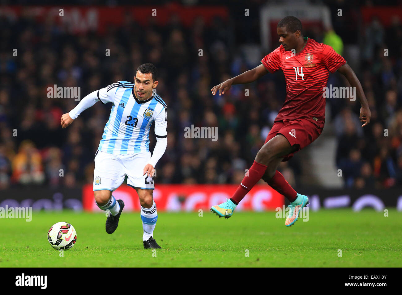 Nov. 18, 2014 - Manchester, United Kingdom - Carlos Tevez of Argentina and William Carvalho of Portugal - Argentina vs. Portugal - International Friendly - Old Trafford - Manchester - 18/11/2014 Pic Philip Oldham/Sportimage. Stock Photo