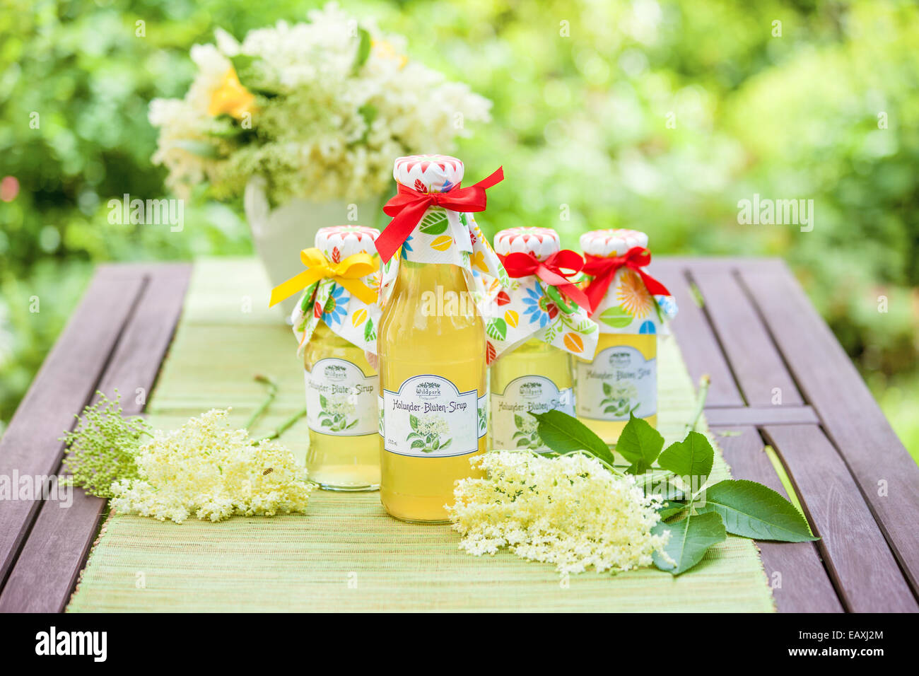 Bottles with elderflower syrup in the garden Stock Photo