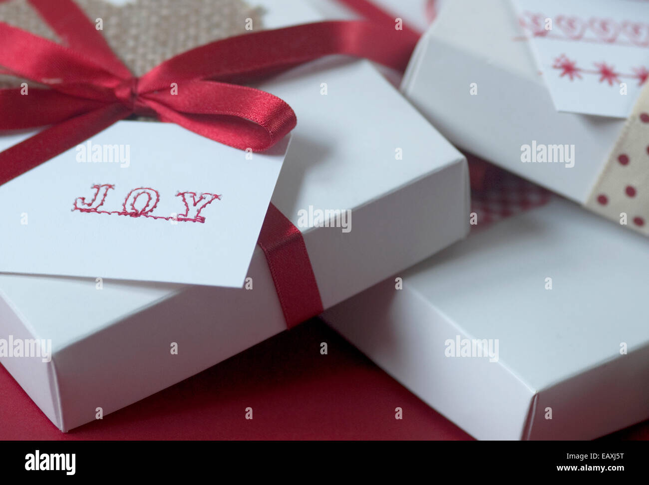 Still life concept image of white boxes gift wrapped with the word Joy
