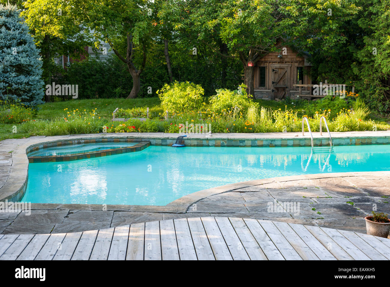 deck garden front backyard with outdoor inground residential swimming pool garden deck and stone patio garden deck garden front backyard with outdoor inground residential swimming pool garden deck and stone patio garden