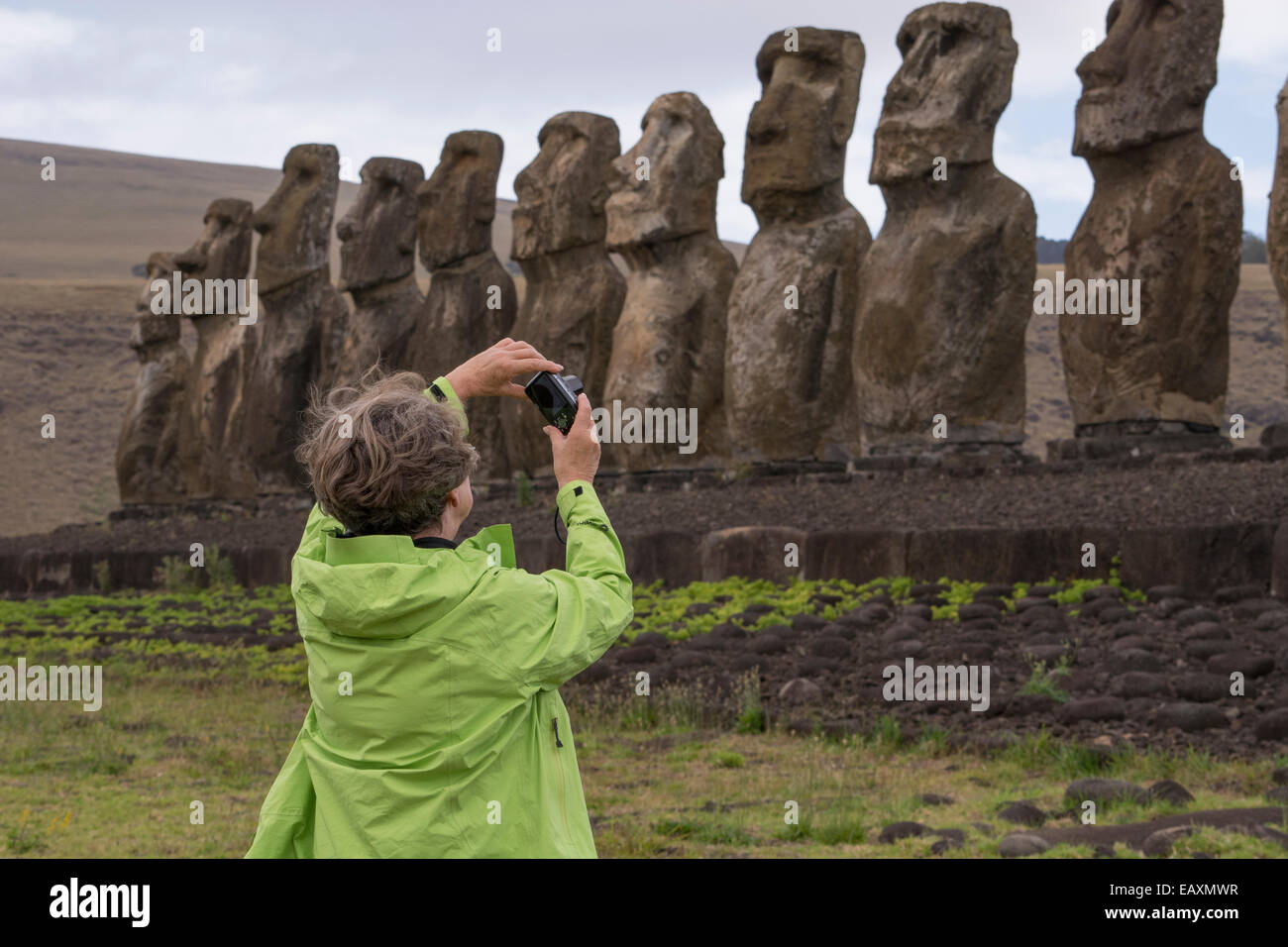 Chile, Easter Island, Hanga Nui. Rapa Nui National Park, Ahu Tongariki (aka Tonariki). Fifteen large moi with tourist. Stock Photo