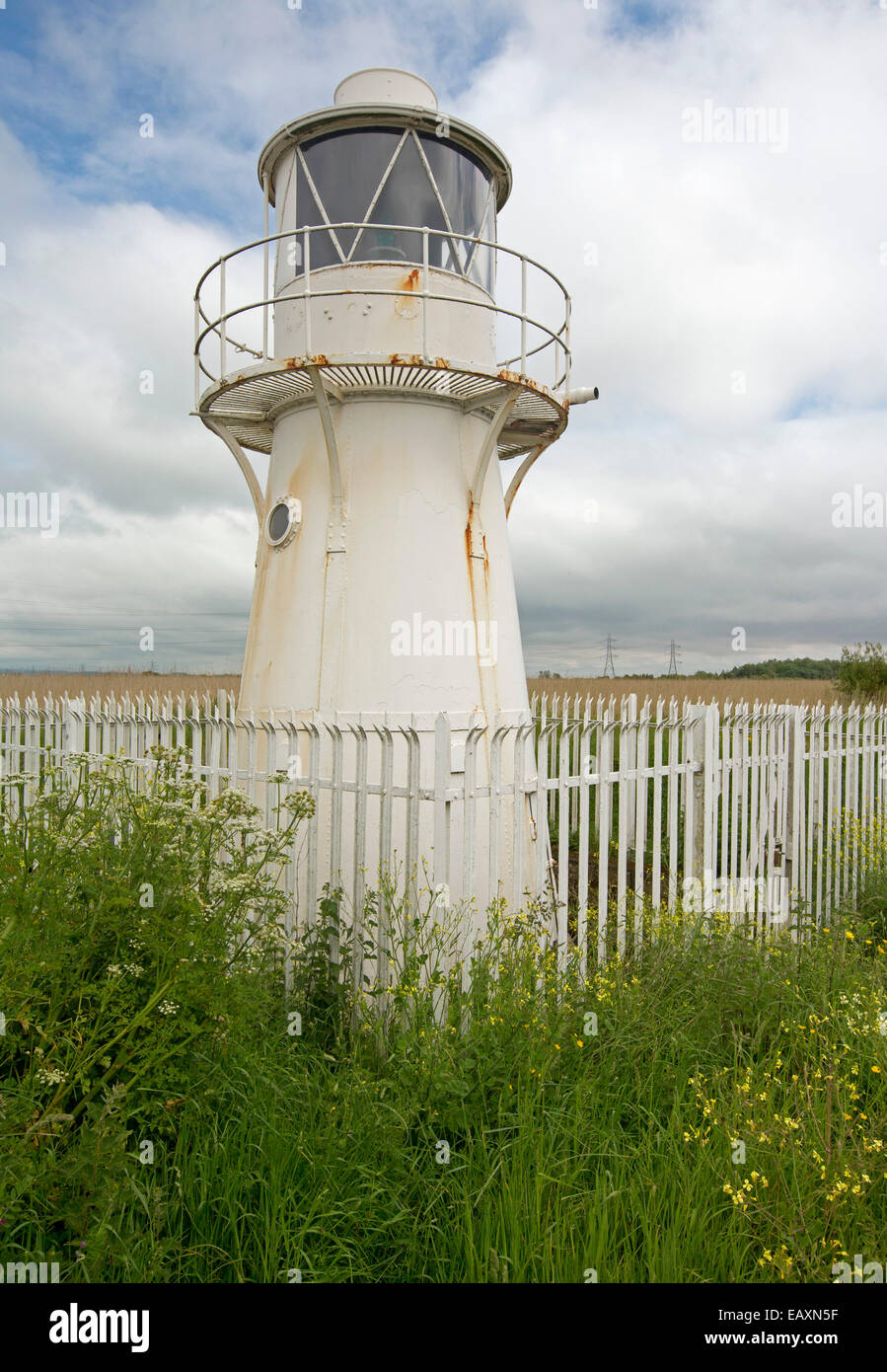 Old operational East Usk lighthouse on Severn River estuary at entrance to River Usk surrounded by wildflowers at Newport Wales Stock Photo