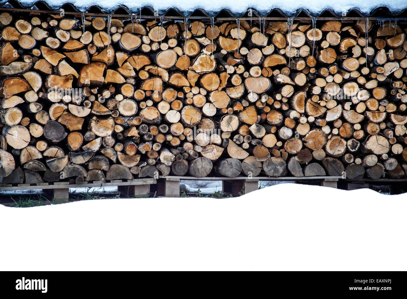 Wood pile of fire wood, stacked under a little roof Stock Photo