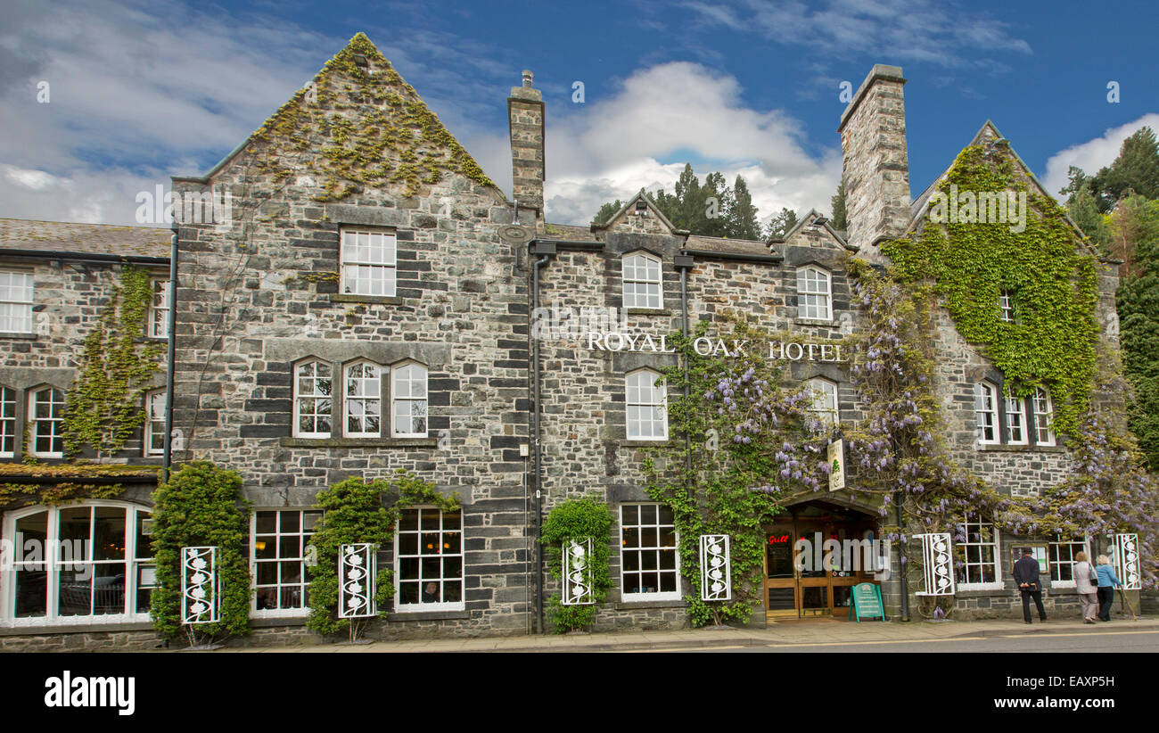 Historic Royal Oak Hotel with wisteria over grey stone facade at Welsh village of Betws y Coed, Snowdonia National Park Wales Stock Photo