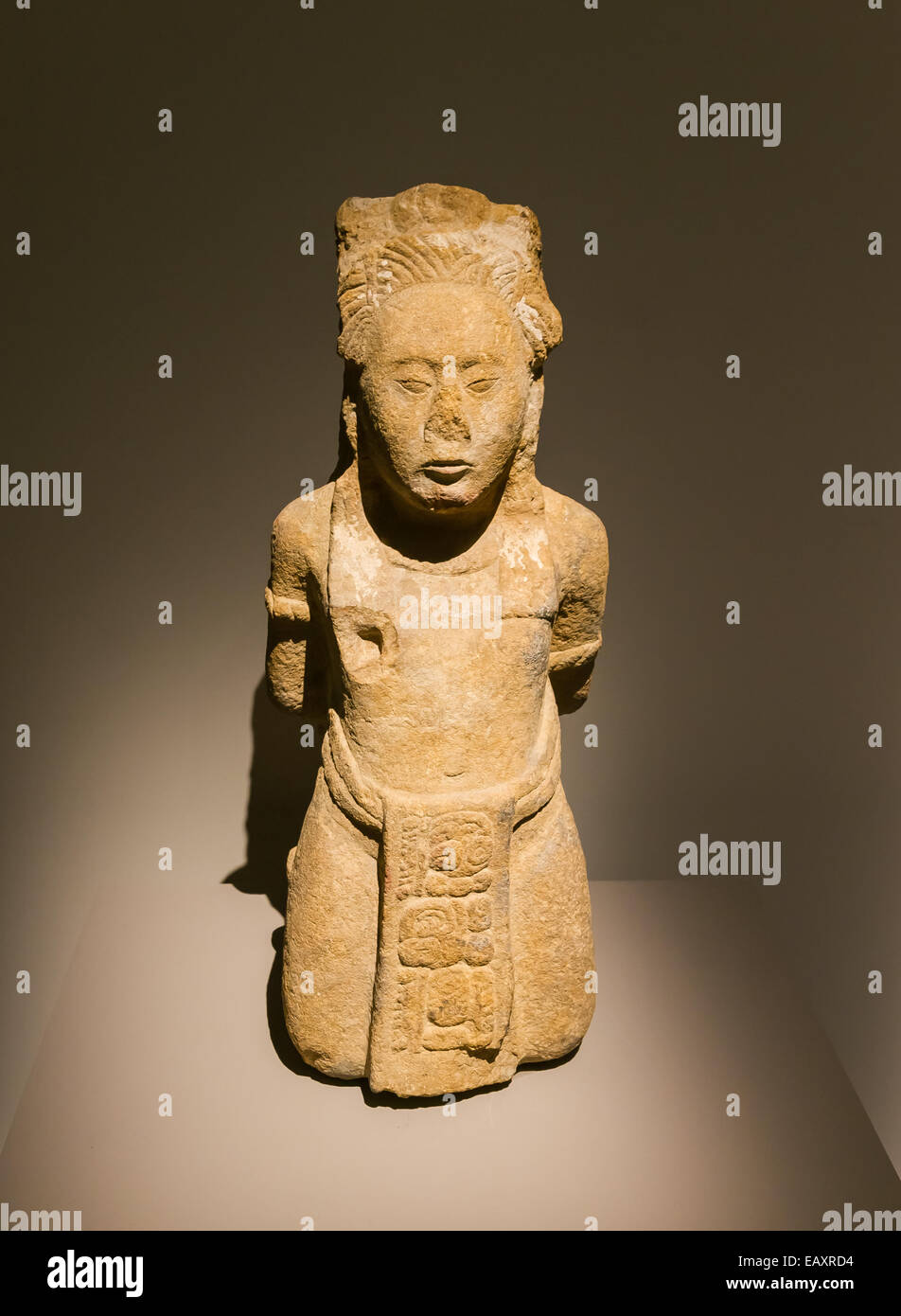 Monument n°151 of Toniná, Chiapas, Mexico, depicting a bound prisoner. Limestone, classical-recent era (600 - 900 C.E.) The glyphs mean that the man is a aj k'uhu'n, a high ranked religious and political man. Stock Photo