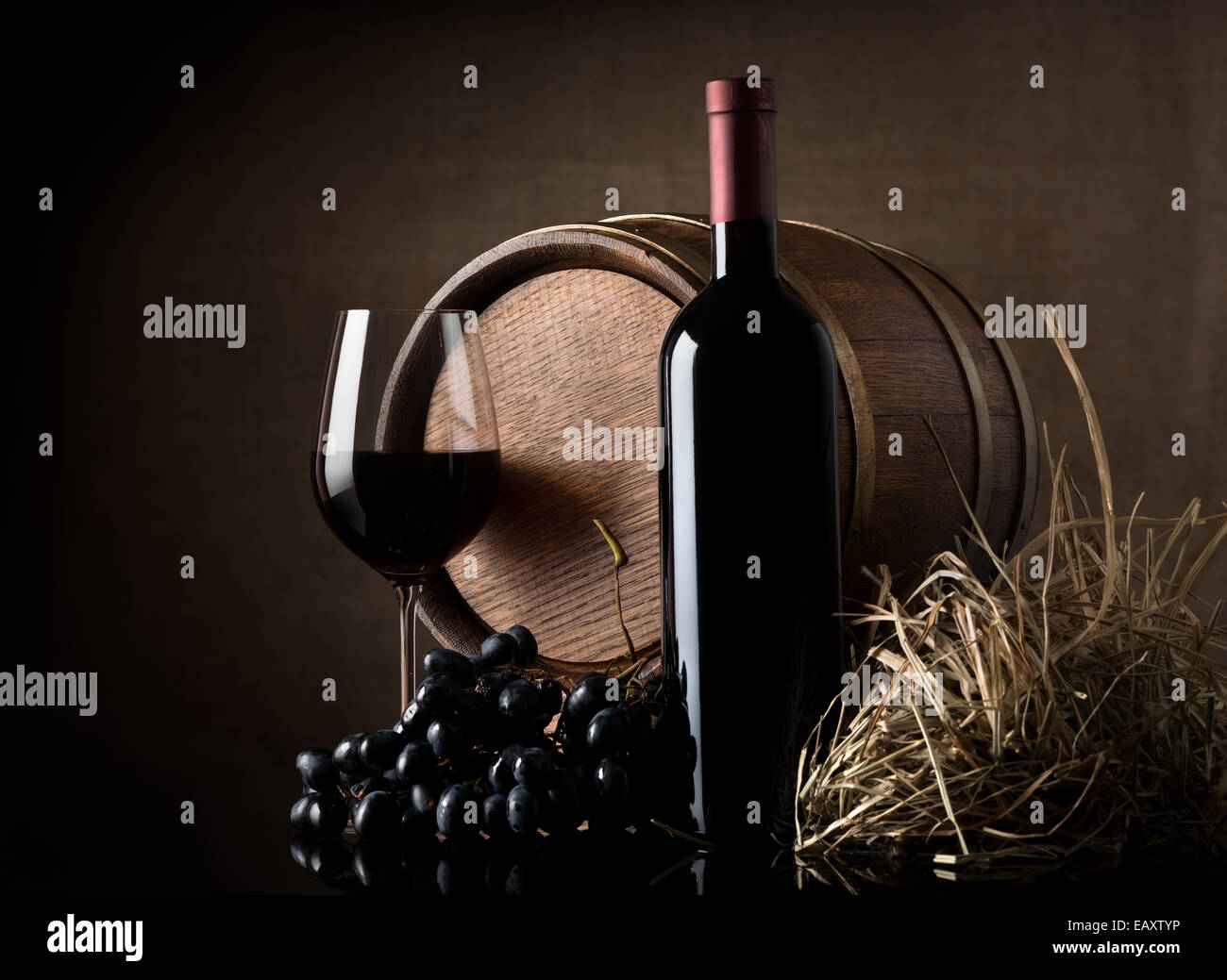 Wine with grape and barrel on brown background Stock Photo