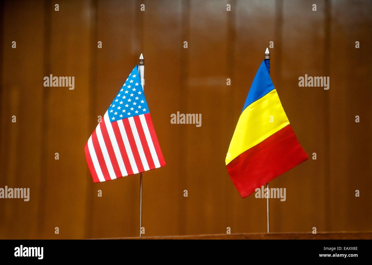 American and romanian table flags at a press conference Stock Photo