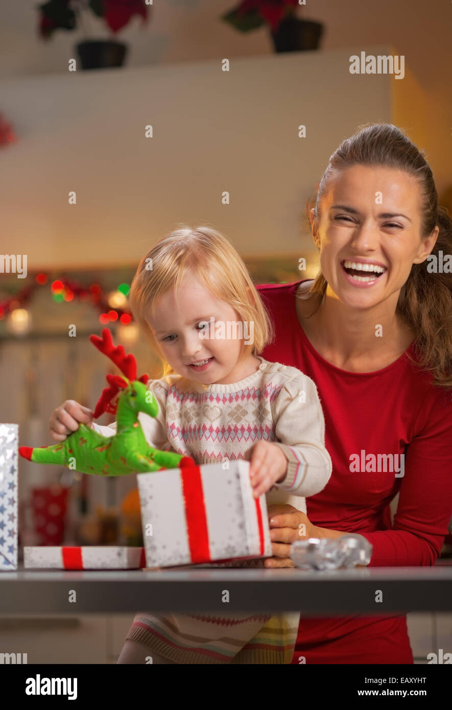 Portrait of smiling mother and baby opening christmas present box Stock Photo