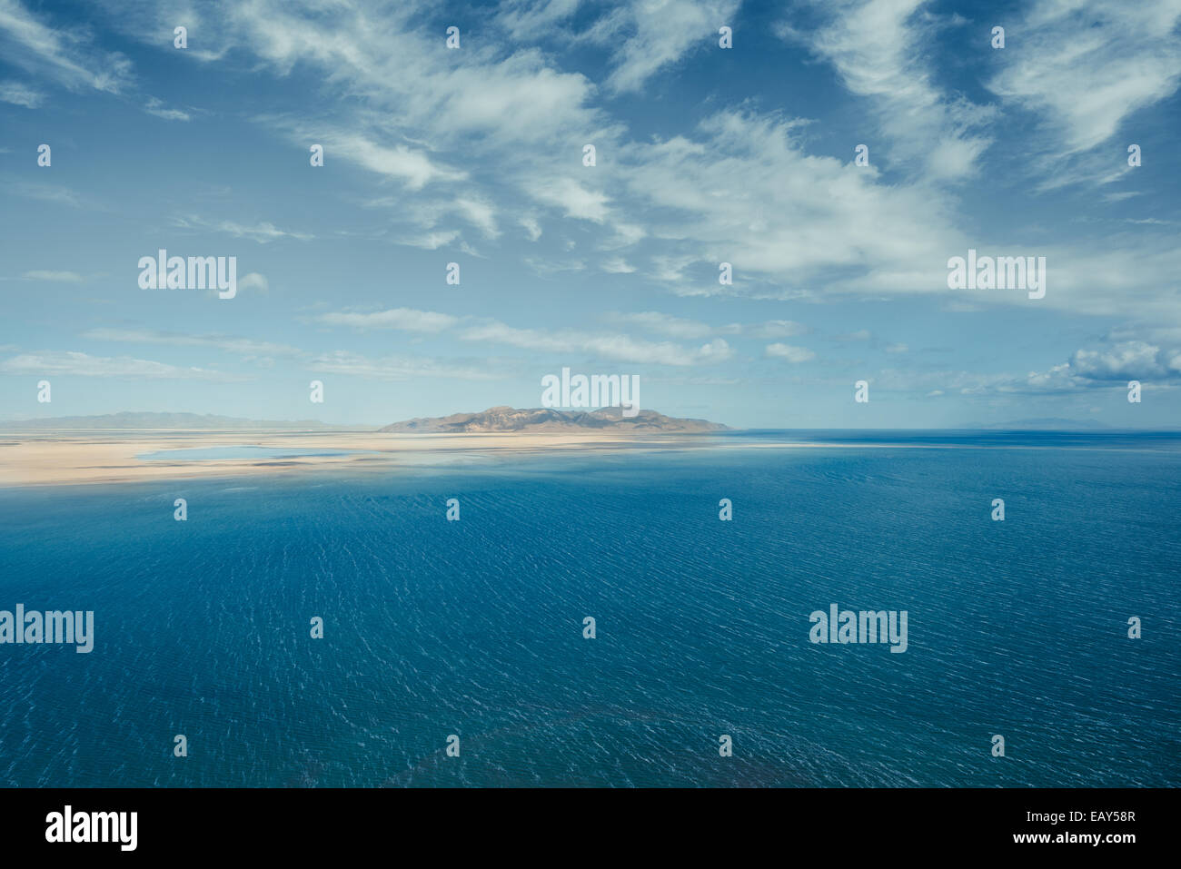 Large body of water juxtaposed with a dry desert. Stock Photo