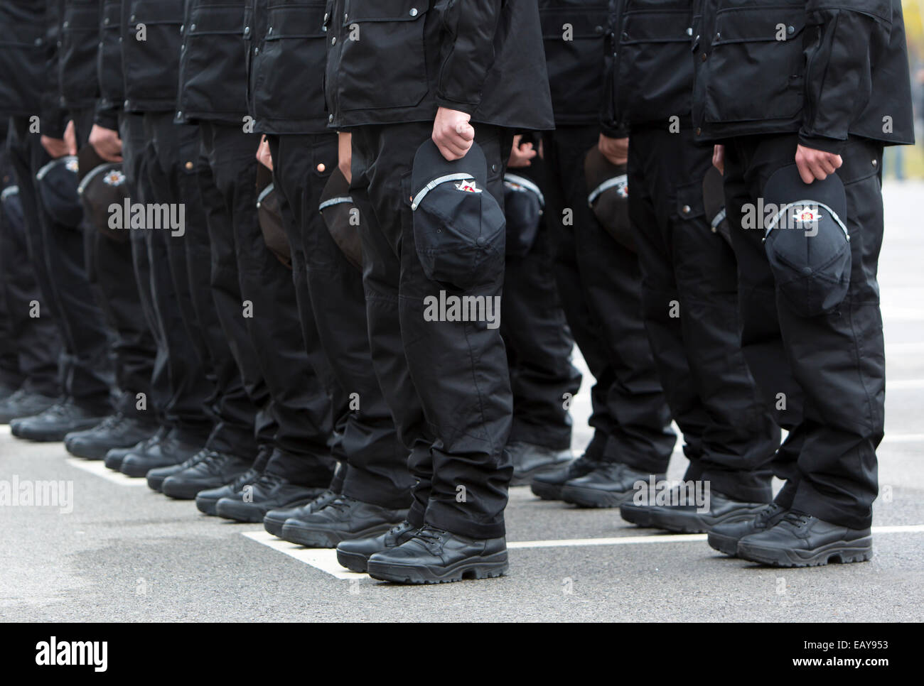 Policemen's black boots holding their hats in formation Stock Photo Alamy