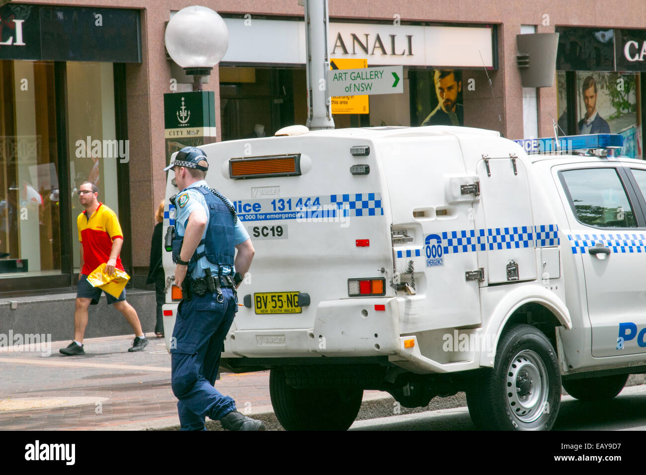 NSW Police officer with his police vehicle car in Macquarie street,Sydney CBD,NSW,Australia Stock Photo