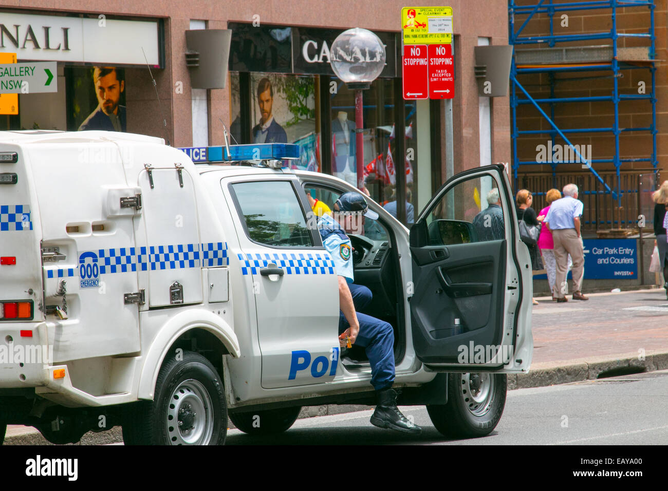 Australian new south wales police officer exits his police car in macquarie street,Sydney,australia Stock Photo