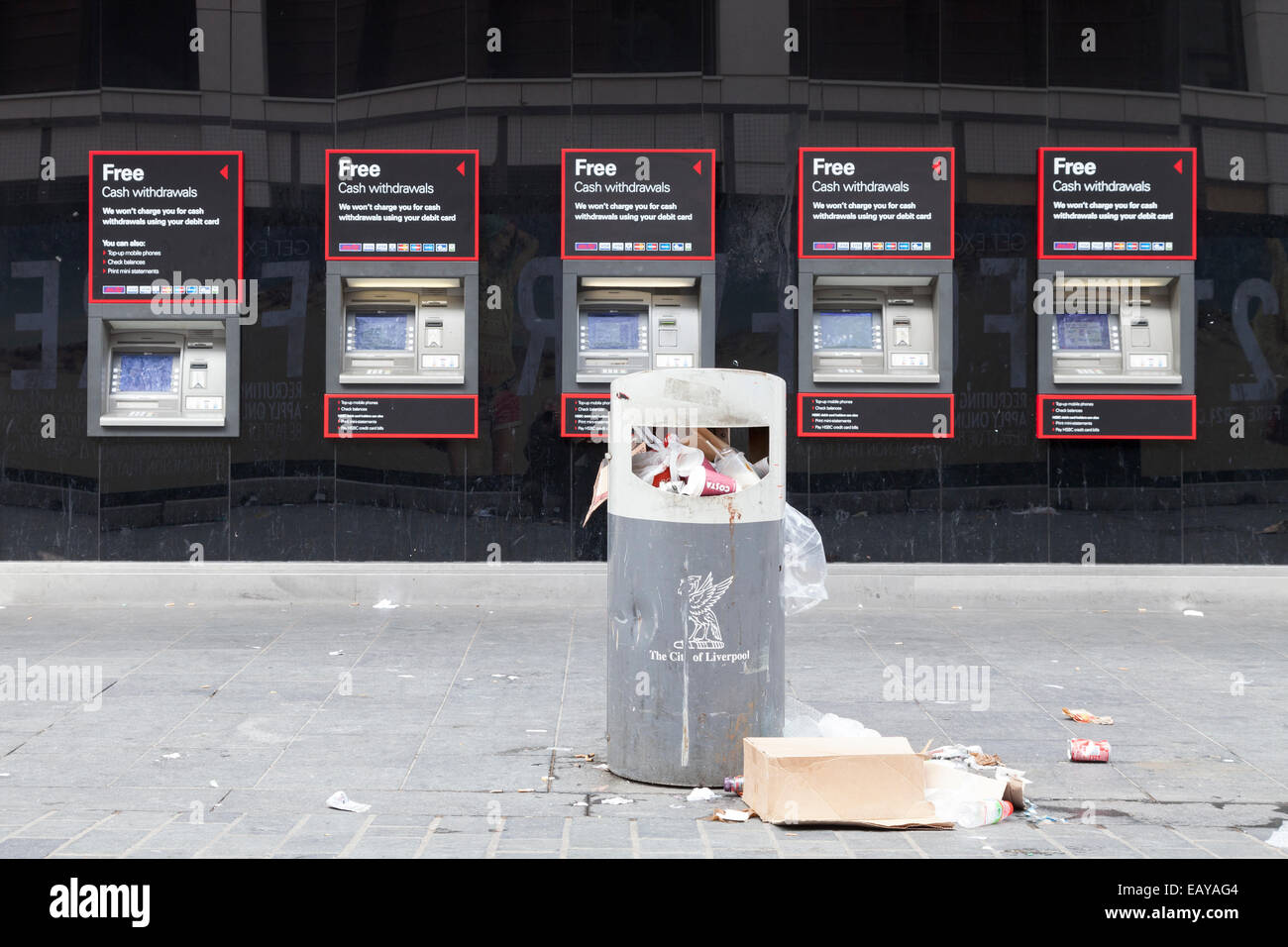 An overflowing bin in front of a bank of cash machines in Liverpool