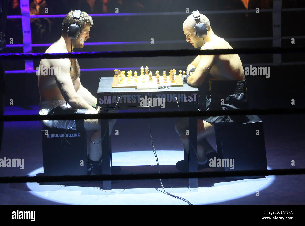 Chess boxers Arik Braun (R) and Felix Bartels sit in front of a chequer  board during the Chess Boxing Championships in Berlin, Germany, 28 July  2012. The chess boxing event took place