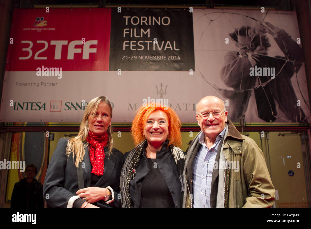 Torino, Italy. 21st November 2014. Torino Film Festival director, Emanuela Martini (center) welcomes German film director Volker Schlöndorff (right) to the opening evening of 32nd Torino Film Festival. Stock Photo