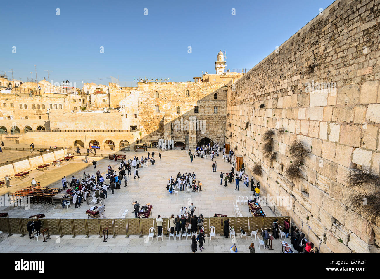 Worshipers pray at the western wall. The wall is the most sacred site in Judaism outside of the Temple Mount itself. Stock Photo