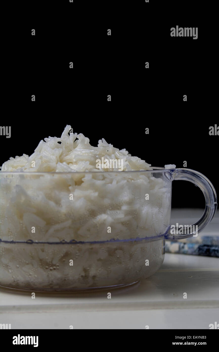 Bowl of white rice, clear container and black chalkboard background Stock Photo