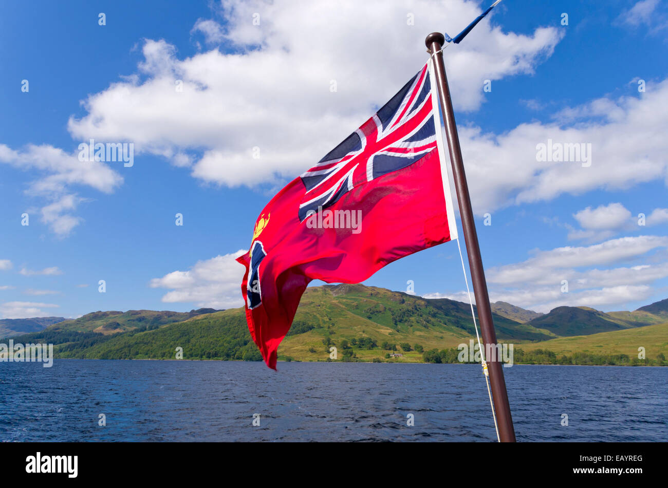 The Red Ensign Flag Flying Over Loch Katrine, Trossachs, Stirlingshire, Scotland, UK Stock Photo