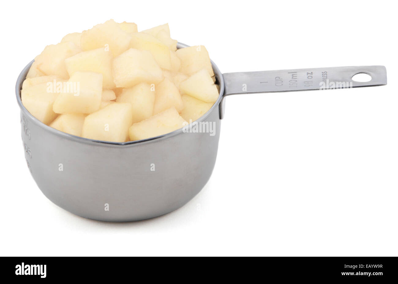 Diced pear flesh in an American cup measure, isolated on a white background Stock Photo
