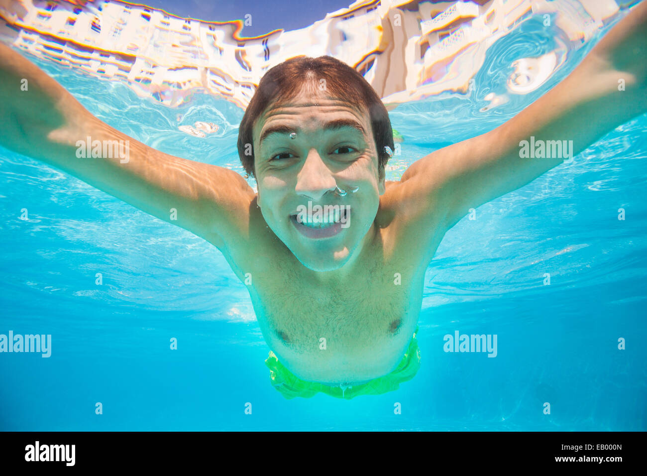 Close up view of smiling man swimming underwater Stock Photo - Alamy