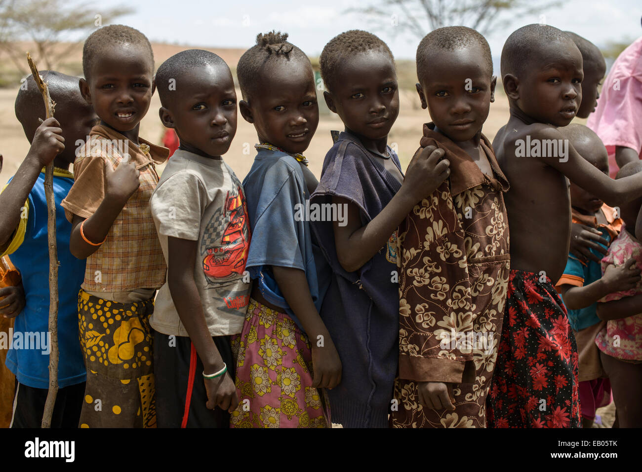 Turkana children queueing for candies in a village, Kenya Stock Photo