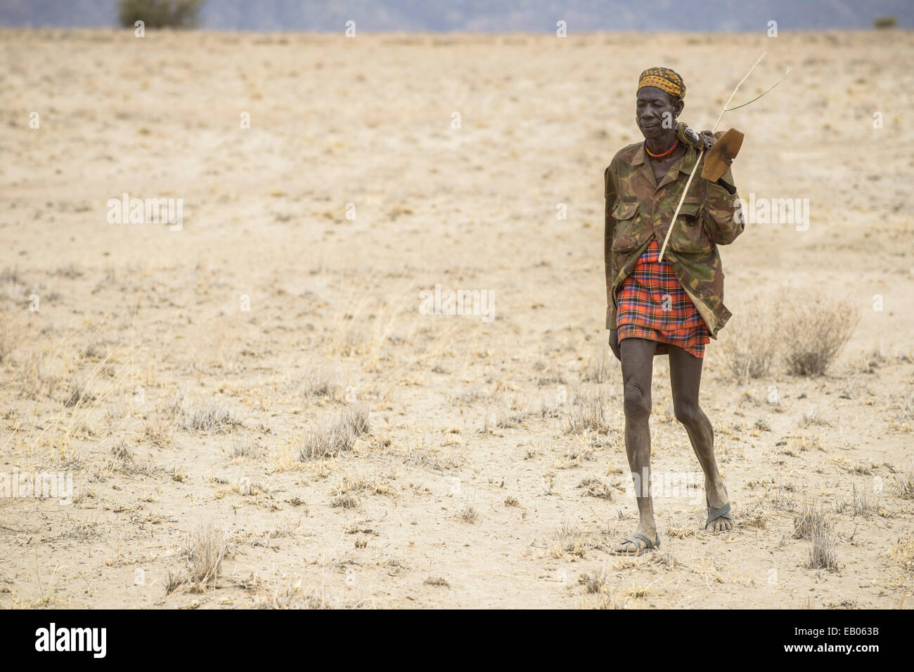 Turkana warrior in the desert, Kenya Stock Photo