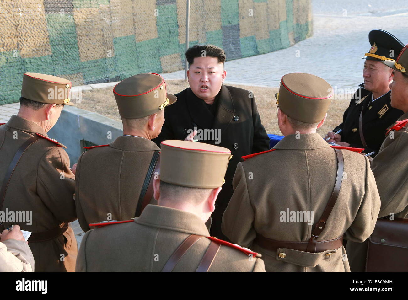 Pyongyang, DPRK. 23rd November, 2014. Photo provided by Korean Central News Agency (KCNA) on Nov.23, 2014 shows top leader of the Democratic People's Republic of Korea (DPRK) Kim Jong Un (C) talking to officers during a combined joint drill of the units under KPA Large Combined Units 572 and 630. Kim Jong Un watched the whole process of the exercise and required all military units to rehearse under simulated conditions of a real war and be well prepared at all times. (Xinhua/KCNA) Credit:  Xinhua/Alamy Live News Stock Photo