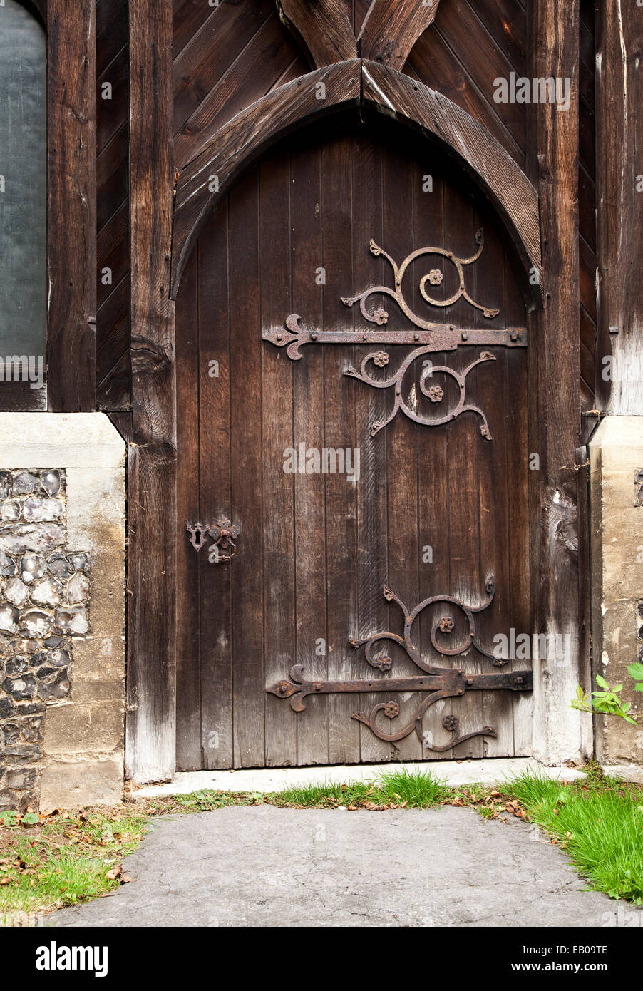 Old rustic Church door with ornate hinges Stock Photo