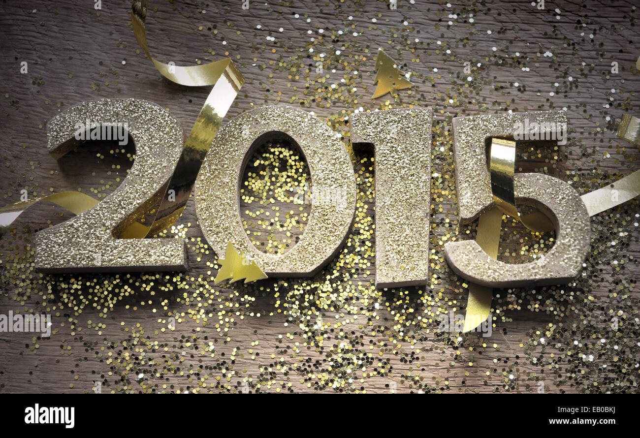 golden 2015 figures on wooden plank with glitters Stock Photo